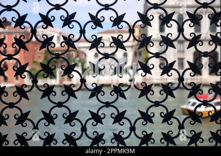 Detail of an ancient window with grating in wrought iron. Venice Stock Photo