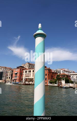 Blue and white wooden mooring pole in Venice. Stock Photo