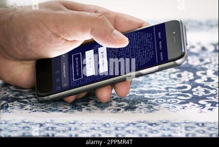 hand holding a phone with Midjourney website on the screen Stock Photo