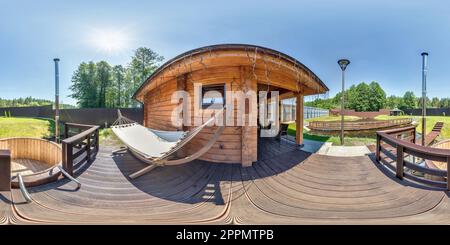 360 degree panoramic view of full seamless hdri 360 panorama near wooden vacation homestead house with hammock in equirectangular spherical projection.VR content,