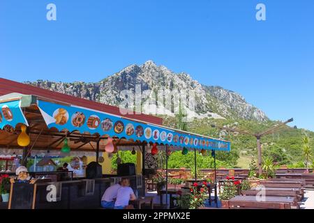 Kemer, Antalya, Turkey - May 11, 2021: Street cafe at road at Kemer, Antalya Stock Photo