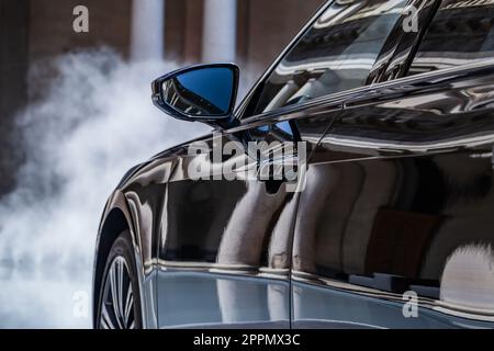 MILAN, ITALY - APRIL 16 2018: Audi city lab. Close up view of the shiny side panel of an audi car and the rear view mirror. Stock Photo