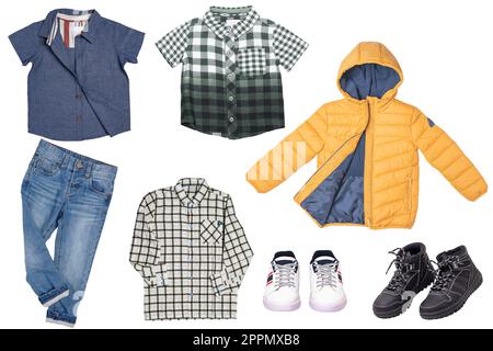 Collage set of little boys spring clothes isolated on a white background. Denim trousers or pants, a pair of shoes, sneaker, cap, shirts and jacket for child boy. Children's autumn and winter fashion. Stock Photo