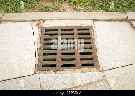 sewerage grid closeup in the city Stock Photo