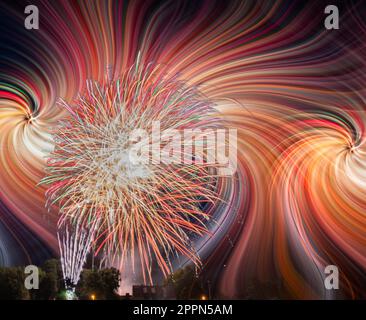 Colorfull fireworks display on the night sky with twirl effect Stock Photo