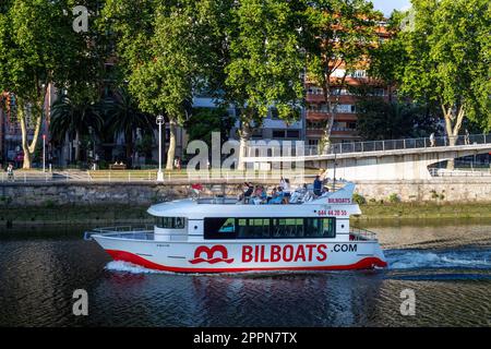 Bilbao river cruise boat on the Nervion river passing the Zubizuri bridge designed by architect Santiago Calatrava, Bilbao, Basque Country, Spain Stock Photo