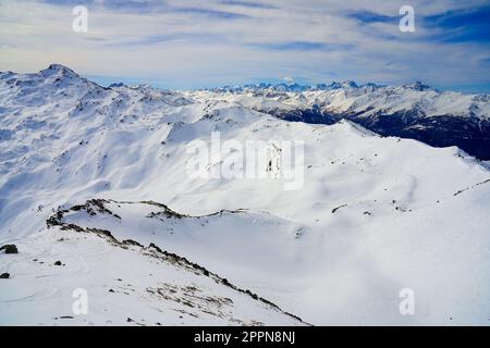 Snowy mountain range of Les Écrins in the French Alps, as seen from the Peak of La Masse above Les Ménuires ski resort Stock Photo