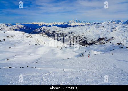 Snow covered mountain range offering a view over the Mont Blanc in the French Alps - Valley of Les Ménuires as seen from the summit of La Masse in win Stock Photo