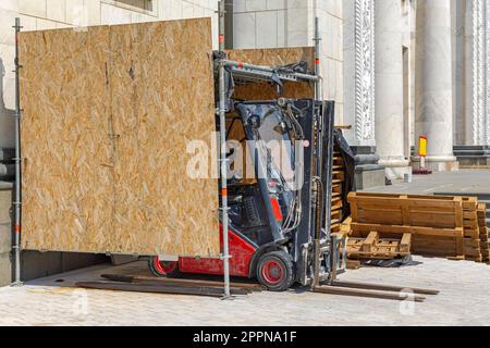 Forklift in Improvised Temporary Garage Made From Particle Boards Construction Site Stock Photo