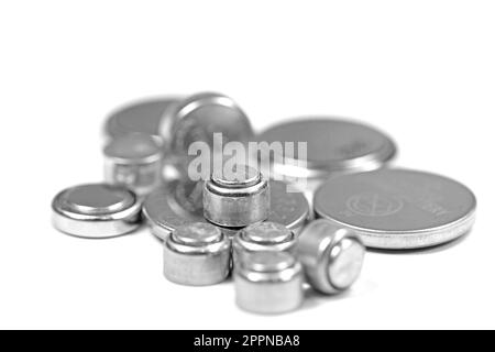 Various button cells against white background Stock Photo