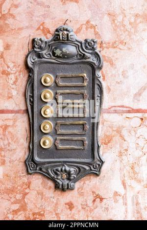 Old vintage rusty doorbells on a marble wall Stock Photo