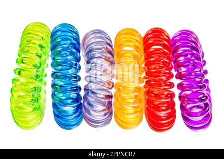 Closeup of various isolated spiral hair ties Stock Photo