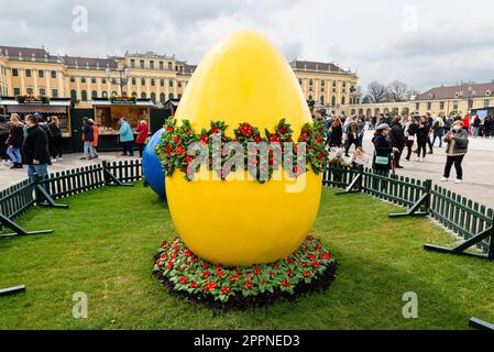 Large blue and yellow Easter egg decoration at the Easter market in the courtyard of Schönbrunn Palace, Vienna Stock Photo