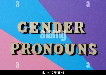 Gender Pronouns, words in wooden alphabet letters isolated on blue, pink and purple background Stock Photo