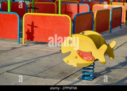 Childrens playground outdoors with a rocking play tool in bright colors. Stock Photo