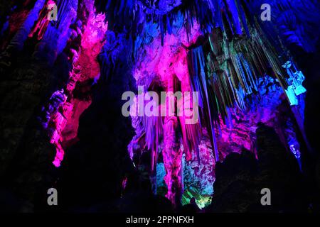 Colored lights inside Saint Michael's cave in the rock of Gibraltar in southern Spain Stock Photo