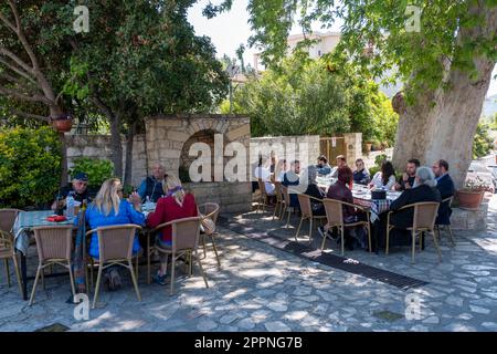 Customers enjoy Sunday lunch outside at the Platanos Tavern, Lania village, Cyprus Stock Photo