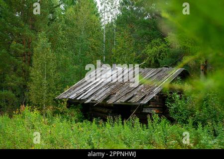 hunting lodge in Siberia. an old abandoned wooden house in the taiga Stock Photo