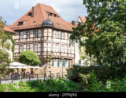 BAMBERG, GERMANY - SEPTEMBER 4: Tourists at a cafe in Bamberg, Germany on September 4, 2015. The historic city center of Bamberg is a listed UNESCO Stock Photo