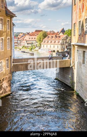 BAMBERG, GERMANY - SEPTEMBER 4: Tourists at the bridge to Altes Rathaus in Bamberg, Germany on September 4, 2015. The historic town hall was built in Stock Photo