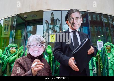 London, UK. 24th April 2023. Protesters wearing Environment Secretary Therese Coffey and Jacob Rees-Mogg masks perform outside Defra on the fourth and final day of Extinction Rebellion's protests in Westminster. Credit: Vuk Valcic/Alamy Live News Stock Photo