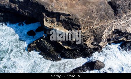 Aerial view of the stairs leading down to the sea caves of Ajuy, dug out of limestone cliffs on the western coast of Fuerteventura in the Canary Islan Stock Photo