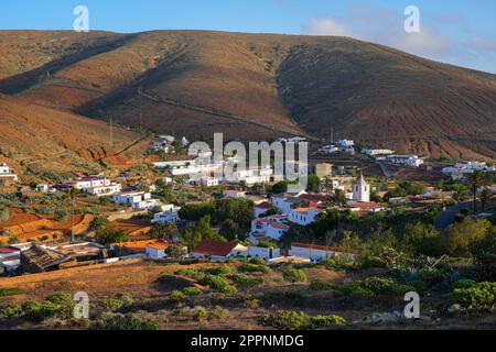 Aerial view of Betancuria, the former capital city of Fuerteventura island in the Canaries, Spain - Rural town with a white bell tower in a valley in Stock Photo