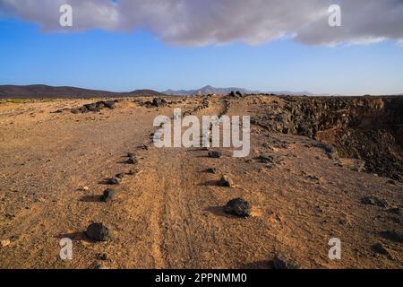 Walking trail at the top of the cliffs overlooking the Playa de la Escalera (Staircase Beach) on the western coast of Fuerteventura in the Canary Isla Stock Photo