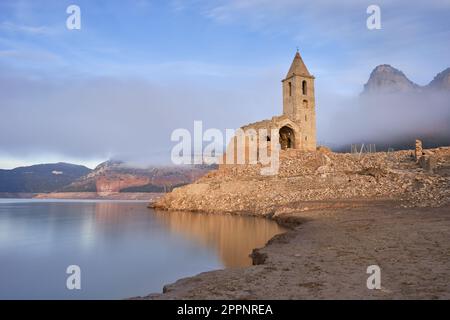 The Romanesque-style church of the Sau swamp uncovered due to the historic drought. Tourism in Catalonia, Osona, Barcelona, Spain Stock Photo