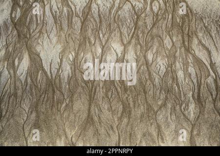 Patterns in the sand on a beach sand left by the sea as the tide went out Stock Photo