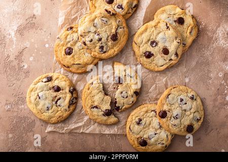 Chocolate chip cookies with flaky salt on parchment paper, homemade freshly baked cookies Stock Photo