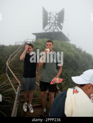 Man Hiking Stairway to Heaven (Haiku Stairs) on Oahu, Hawaii. High quality photo. Looking up the stairs. Stock Photo