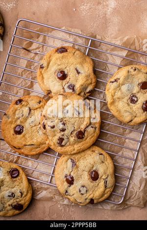 Chocolate chip cookies with flaky salt on a cooling rack, homemade freshly baked cookies Stock Photo