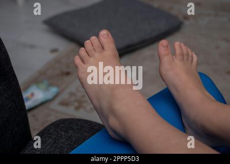 Mom hold her child legs Stock Photo