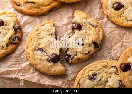 Chocolate chip cookies with flaky salt on parchment paper, homemade freshly baked cookies Stock Photo