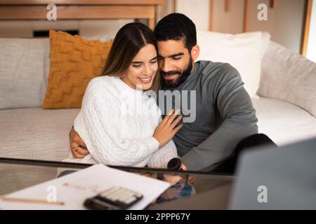 Glad young arabic husband hugging wife at date, enjoy tender moment