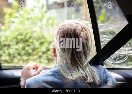 Beauty cool girl sitting posing on a car, reflection in glass