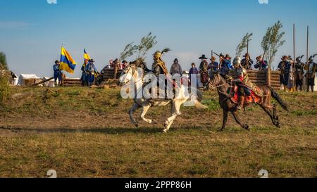 Gniew, Poland, Aug 2020 Horsman warriors, charging through a battlefield in front of fortifications, historical reenactment of Battle of Gniew Stock Photo