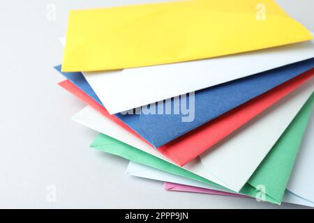Colorful paper envelopes on light background, closeup Stock Photo