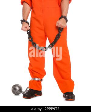 Prisoner in jumpsuit with chained hands and metal ball on white background, closeup Stock Photo