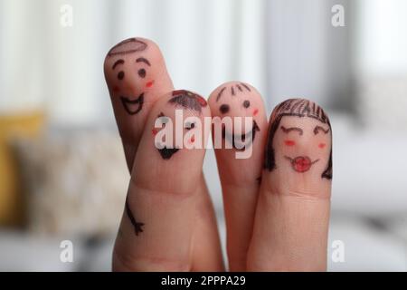 Four fingers with drawings of happy faces on blurred background Stock Photo