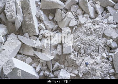 Construction waste debris - remains of white aac - autoclaved aerated concrete brick blocks, closeup detail Stock Photo