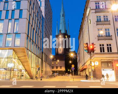 Stockholm, Sweden - 4 October, 2022: A stunning night-time cityscape of Stockholm, illuminated by street lights and the Klara Church in the downtown a Stock Photo