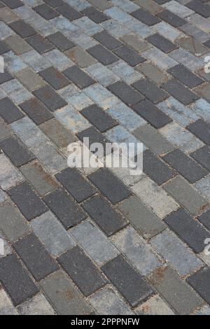 Background in the form of motley gray concrete tiles of a rectangular shape. Stock Photo