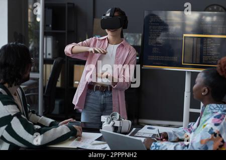 Group of programmers testing new VR glasses during presentation in office Stock Photo