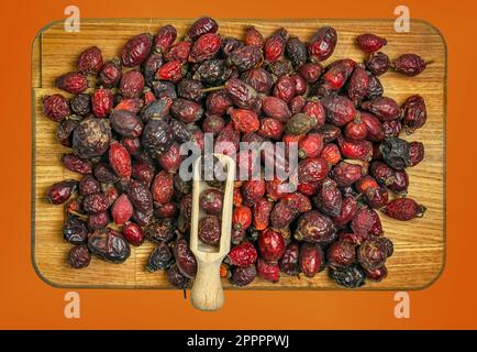 Background made of Dry rose hips. Fharmaceutical raw materials. Healing herbs Rosae fructus. Rosae pseudo-fructus. Dried medicinal herbs raw materials Stock Photo