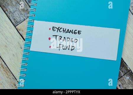 Concept of Exchange, Traded, Fund write on sticky notes isolated on Wooden Table. Stock Photo