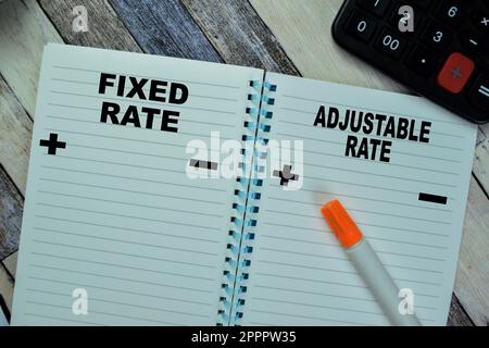 Concept of Fixed Rate and Adjustable Rate write on book isolated on Wooden Table. Stock Photo