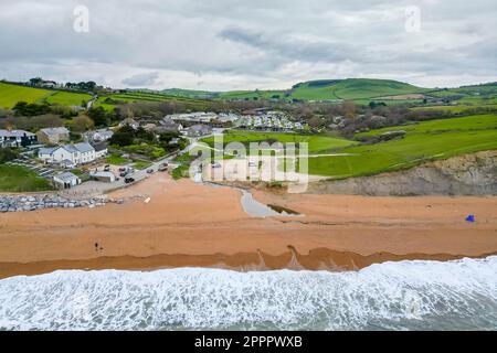 Seatown, Dorset, UK.  24th April 2023.  View from the air of the beach, River Winniford and village at Seatown on the Dorset Jurassic Coast.  In 2022, the sewer storm overflow 500 meters inland next to the River Winniford at the Chideock sewage treatment works owned by Wessex Water, (Permit number: 401068) spilled 35 times for a total of 363.50 hours, discharging into the River. (Source: https://theriverstrust.org/key-issues/sewage-in-rivers) Picture Credit: Graham Hunt/Alamy Live News Stock Photo