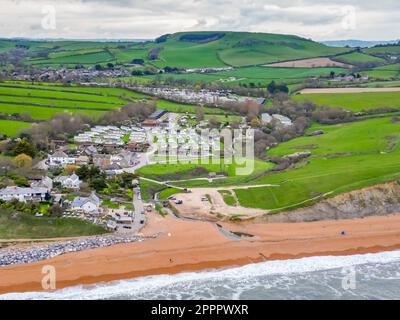Seatown, Dorset, UK.  24th April 2023.  View from the air of the beach, River Winniford and village at Seatown on the Dorset Jurassic Coast.  In 2022, the sewer storm overflow 500 meters inland next to the River Winniford at the Chideock sewage treatment works owned by Wessex Water, (Permit number: 401068) spilled 35 times for a total of 363.50 hours, discharging into the River. (Source: https://theriverstrust.org/key-issues/sewage-in-rivers) Picture Credit: Graham Hunt/Alamy Live News Stock Photo